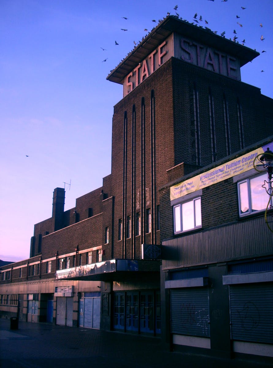 Casa Teva Lleida - Captured at dusk, this historic brick theater with glowing signage stands as an iconic urban structure.